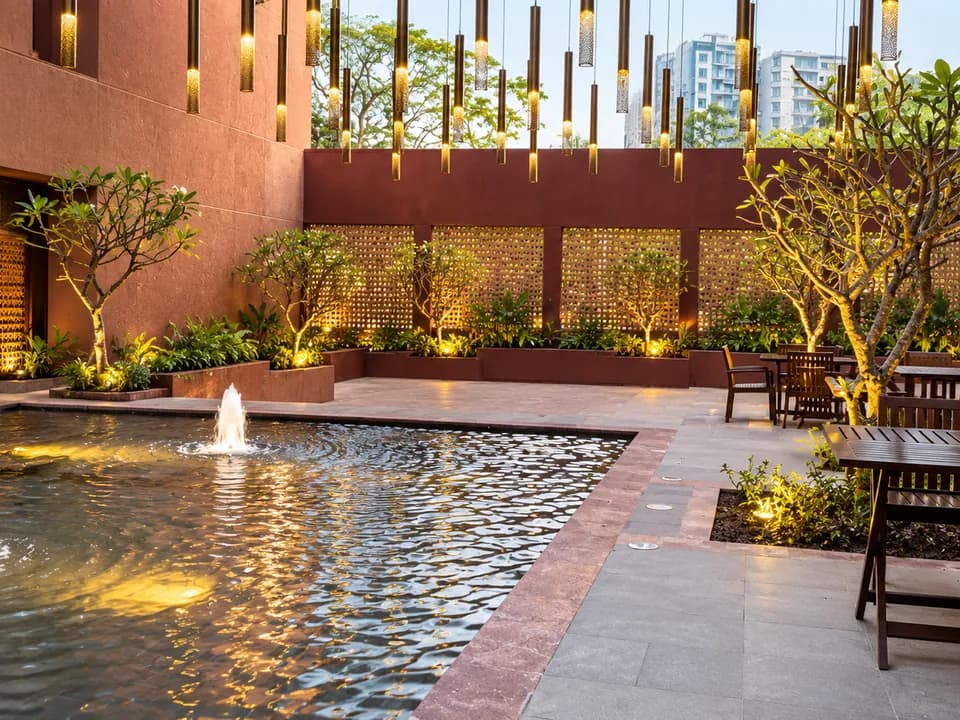 Aga Khan Hospital Karachi courtyard with water feature and pendant lighting.